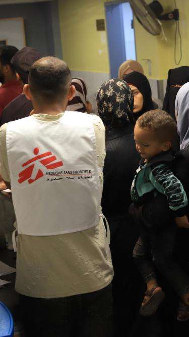 Patient sits in a chair reading